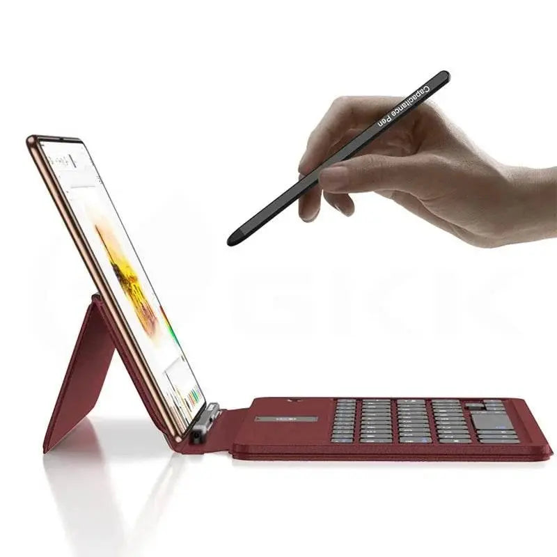 Hand holding black capacitance pen over tablet with red foldable keyboard case on white background