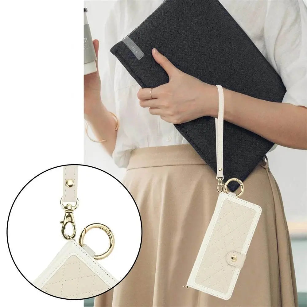 Woman holding laptop with stylish FoldifyCase cream quilted foldable phone case on wrist strap